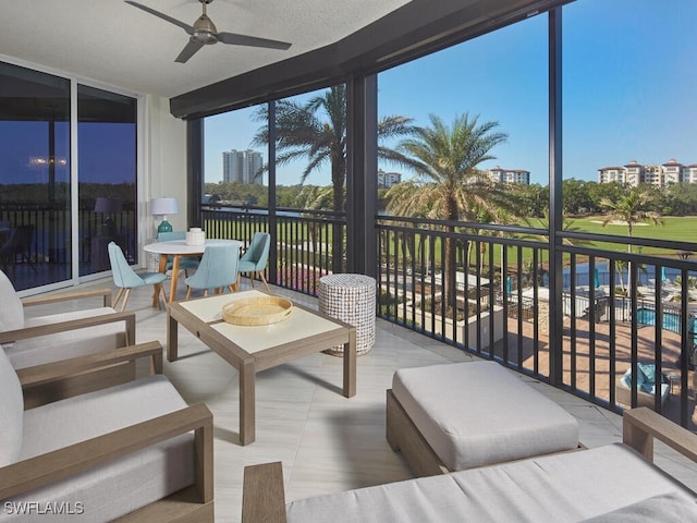 sunroom / solarium featuring ceiling fan