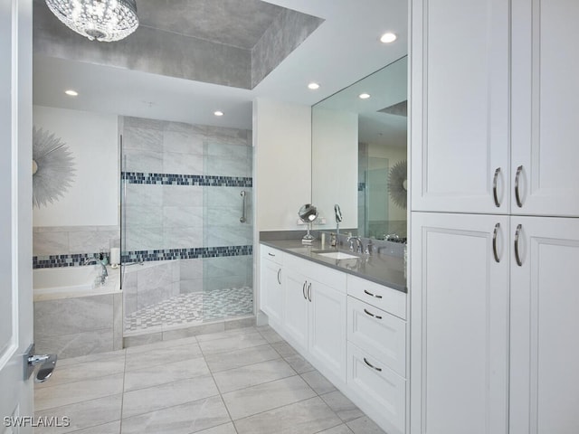 bathroom with tile patterned floors, a chandelier, vanity, and independent shower and bath