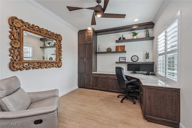 office area featuring built in desk, light hardwood / wood-style floors, ceiling fan, and crown molding