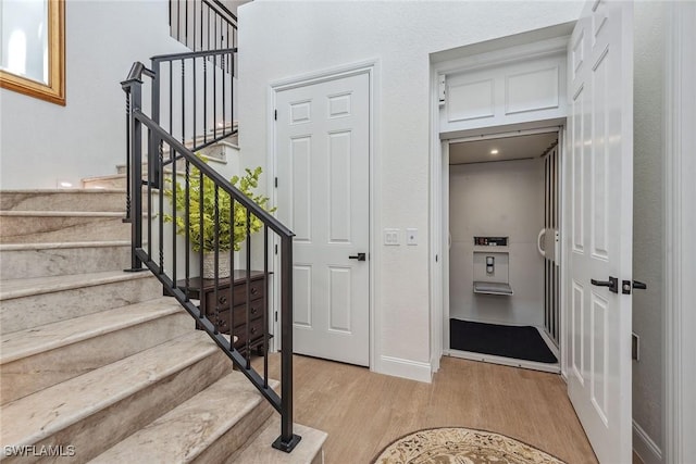 staircase with wood-type flooring