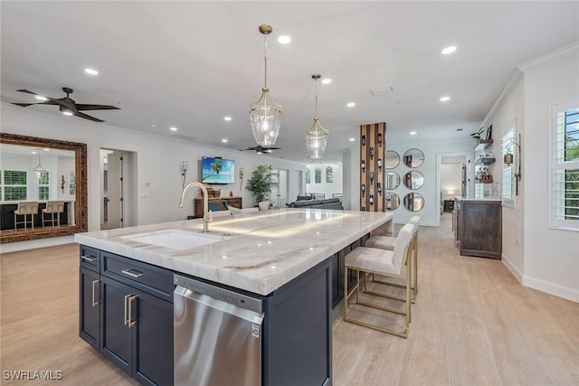 kitchen with dishwasher, a large island with sink, sink, ceiling fan, and decorative light fixtures