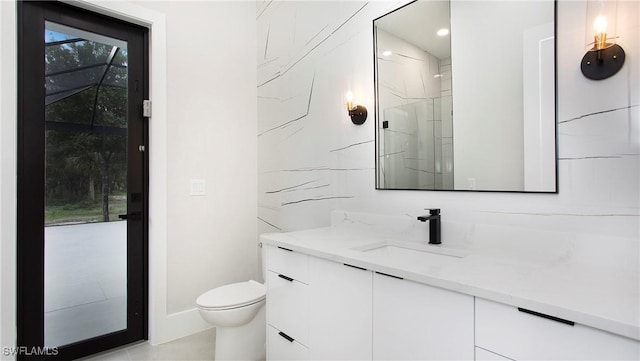 bathroom with vanity, toilet, and a shower