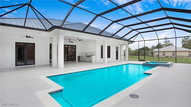 view of pool with a patio area, a lanai, an outdoor kitchen, and ceiling fan