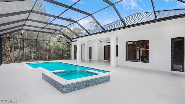 view of swimming pool with a patio, an in ground hot tub, glass enclosure, and ceiling fan