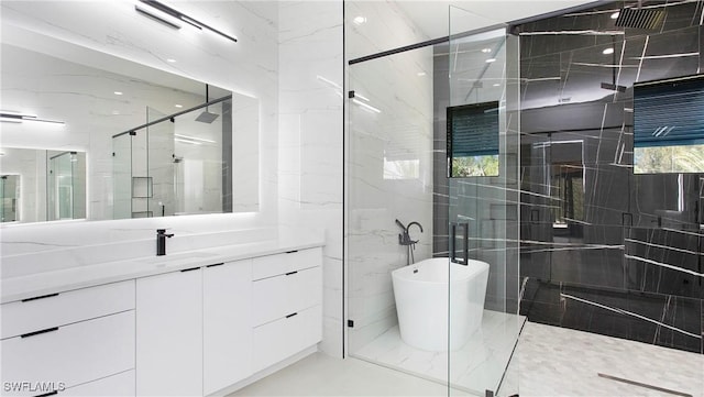 bathroom featuring separate shower and tub and vanity