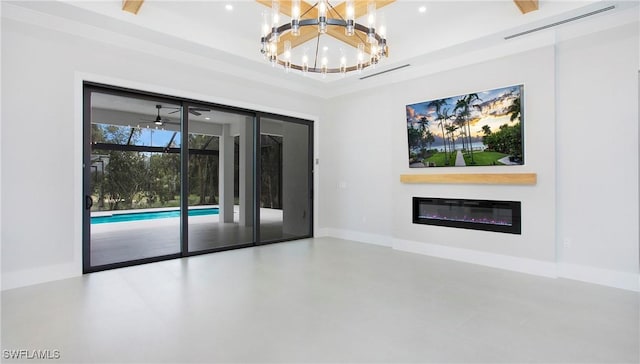 spare room with a notable chandelier and concrete flooring