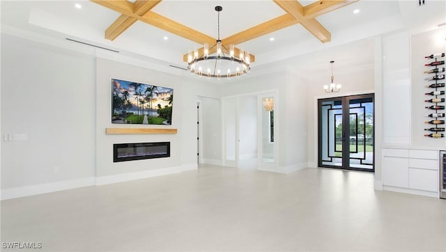 interior space with a notable chandelier, coffered ceiling, a high ceiling, beam ceiling, and wine cooler