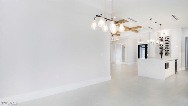 kitchen with beamed ceiling, an island with sink, sink, hanging light fixtures, and coffered ceiling