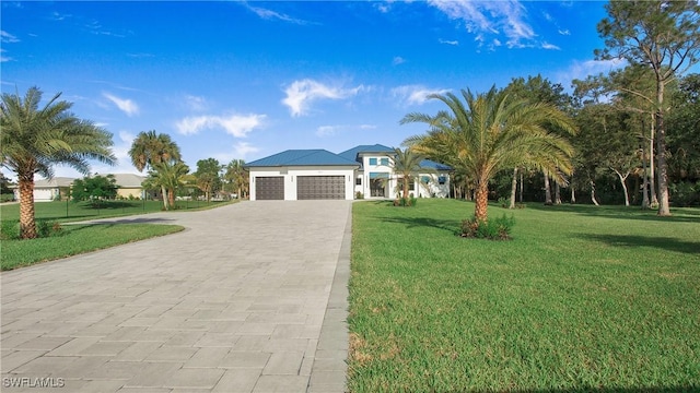 view of front of home featuring a garage and a front yard