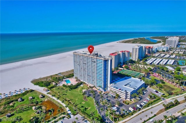 drone / aerial view featuring a beach view and a water view