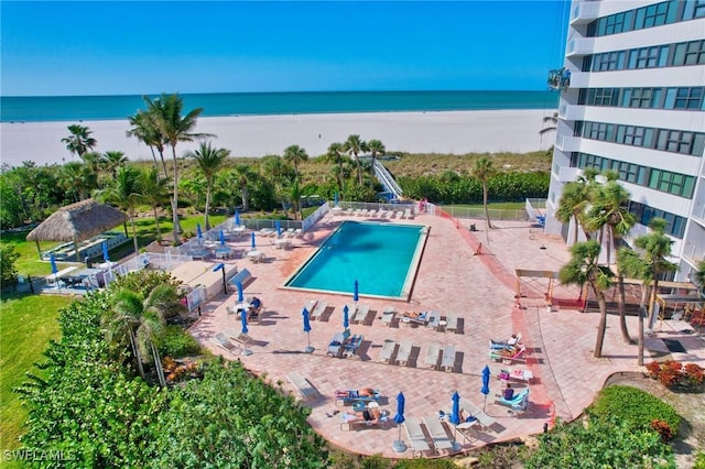 view of pool with a view of the beach and a water view