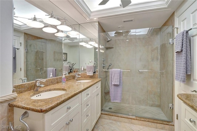 bathroom with tile patterned flooring, walk in shower, crown molding, vanity, and ceiling fan