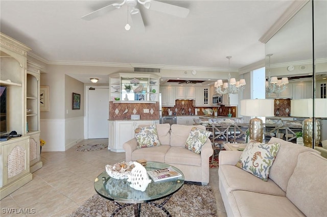 living room featuring ceiling fan with notable chandelier, light tile patterned floors, and crown molding