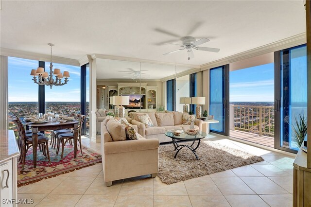 tiled living room featuring ceiling fan with notable chandelier, a wall of windows, and plenty of natural light