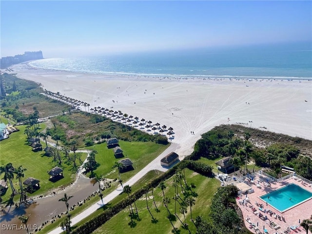 bird's eye view with a water view and a beach view