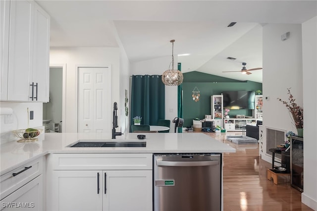 kitchen with dishwasher, white cabinets, vaulted ceiling, and sink