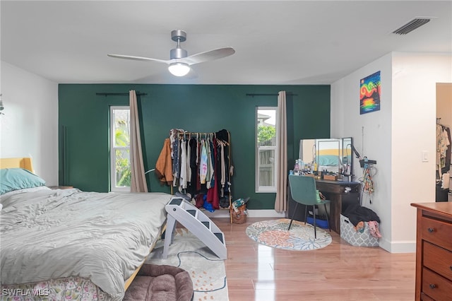 bedroom with light hardwood / wood-style floors and ceiling fan