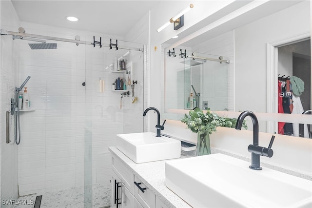 bathroom featuring vanity and a shower with shower door