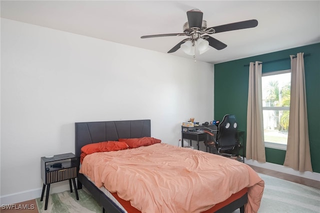 bedroom with hardwood / wood-style floors and ceiling fan