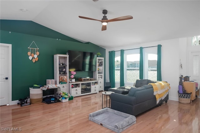 living room with ceiling fan, vaulted ceiling, and hardwood / wood-style flooring