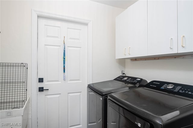 laundry room with cabinets and washer and dryer