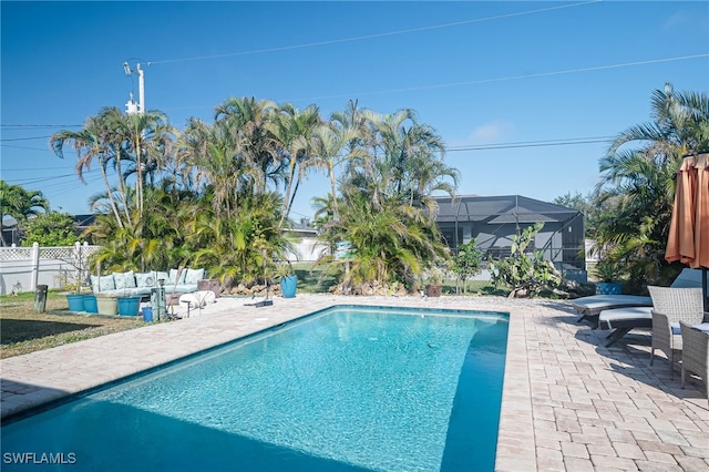 view of swimming pool with a lanai and a patio