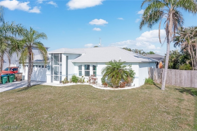 view of front of home with a garage and a front lawn