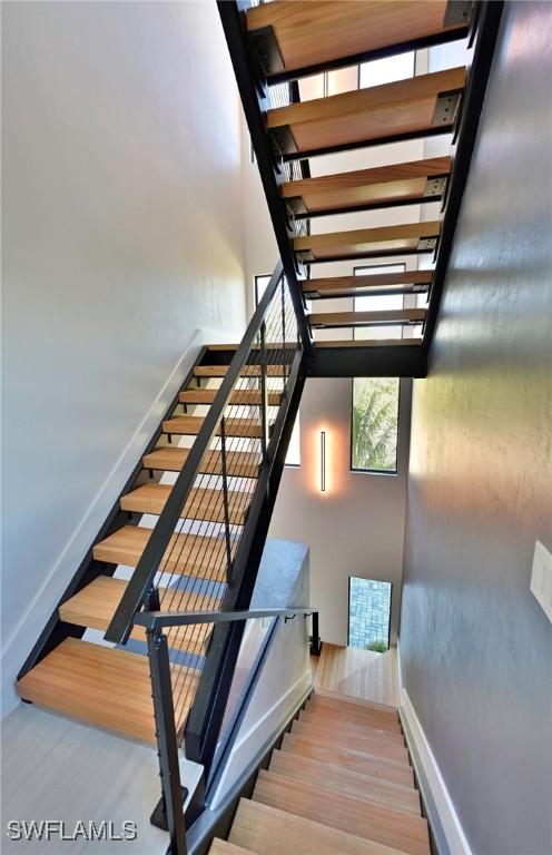 staircase featuring wood-type flooring