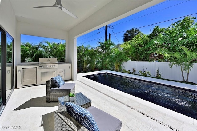 view of patio featuring grilling area, exterior kitchen, a fenced in pool, and ceiling fan