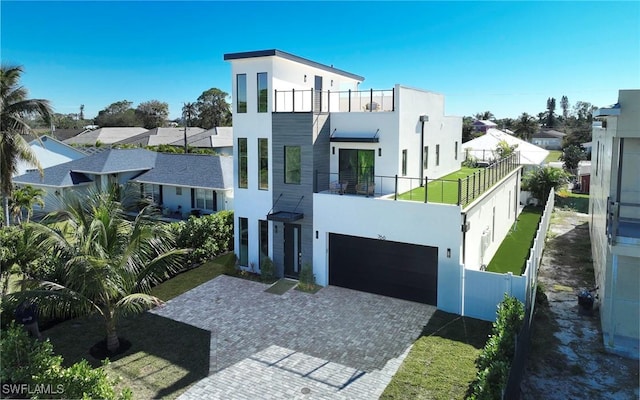 contemporary home featuring a garage and a balcony