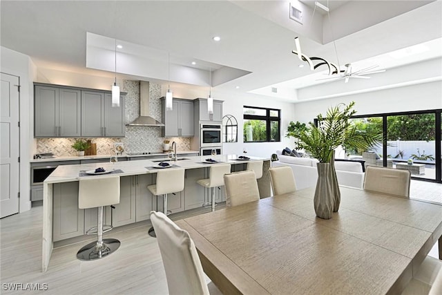 dining room featuring ceiling fan, a tray ceiling, and sink