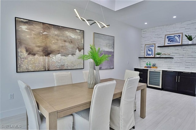 dining room featuring light hardwood / wood-style flooring and wine cooler