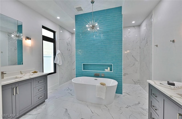 bathroom featuring vanity, tile walls, an inviting chandelier, and shower with separate bathtub