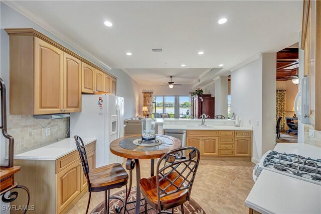 kitchen featuring dishwasher, sink, ceiling fan, ornamental molding, and kitchen peninsula