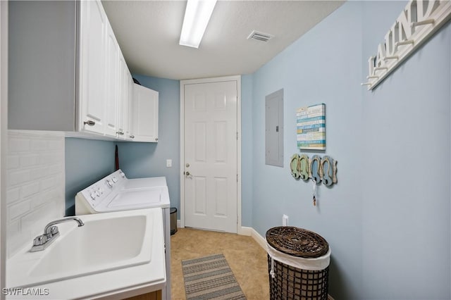 laundry area with sink, cabinets, independent washer and dryer, electric panel, and light tile patterned floors