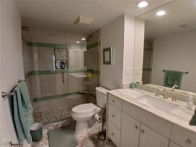 bathroom with toilet, walk in shower, and vanity