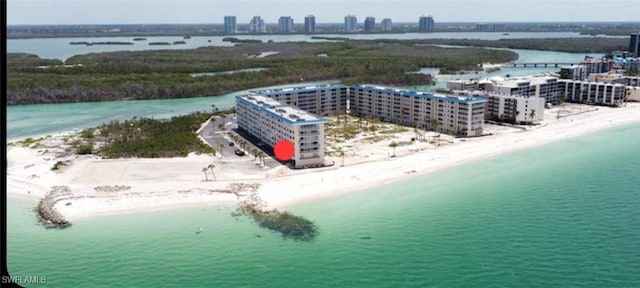 bird's eye view with a water view, a view of city, and a beach view