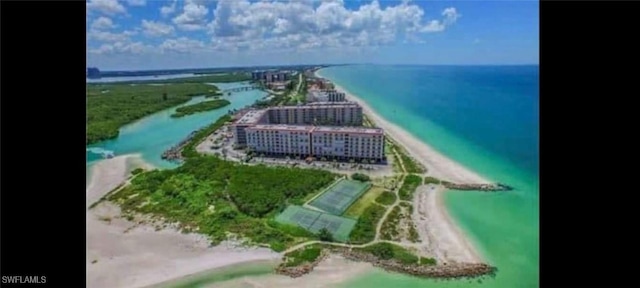 aerial view with a water view and a view of the beach