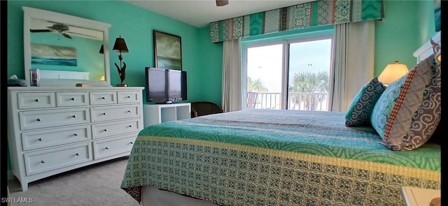 carpeted bedroom featuring ceiling fan and access to exterior