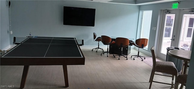 game room with light hardwood / wood-style flooring