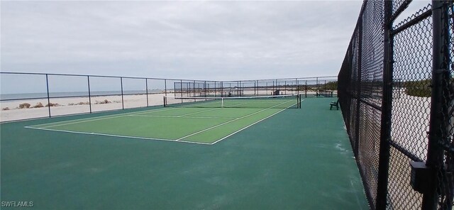 view of sport court with a view of the beach, basketball court, and a water view