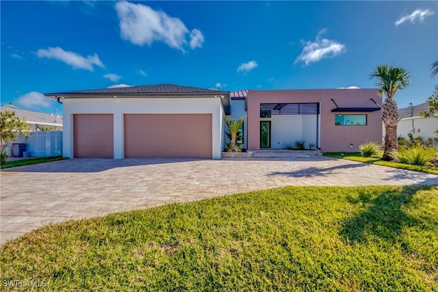 view of front of property with a garage and a front yard