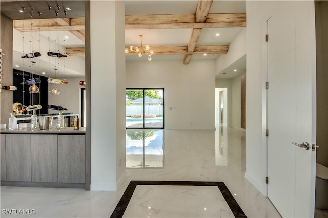 doorway to outside featuring a notable chandelier and beam ceiling