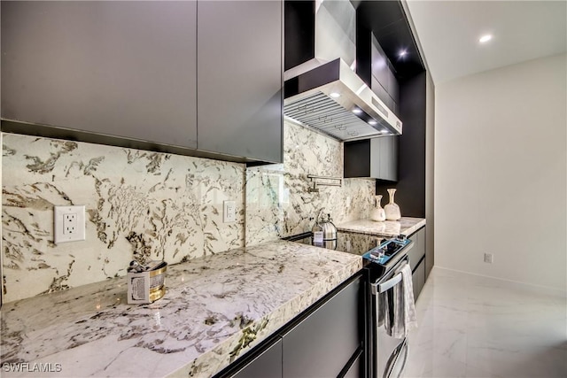 kitchen with tasteful backsplash, wall chimney range hood, light stone countertops, and electric stove