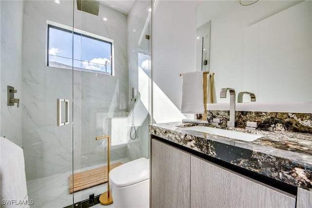 bathroom featuring vanity, toilet, and walk in shower