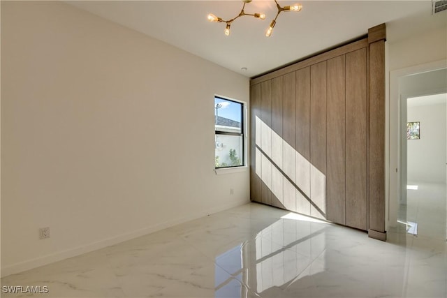 spare room featuring a notable chandelier