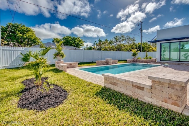 view of pool featuring a yard and a patio