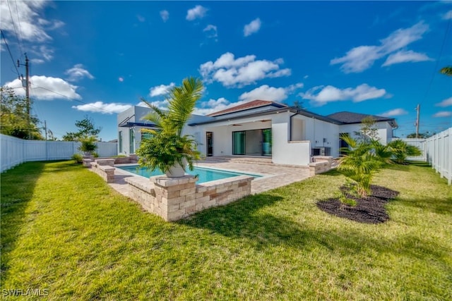 back of property featuring a fenced in pool, a patio, ceiling fan, and a lawn