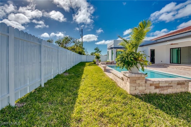 view of yard featuring a fenced in pool and a patio area