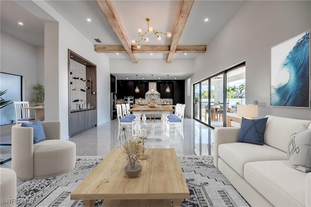 living room with a high ceiling, an inviting chandelier, and beam ceiling